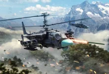 A Ka-52 attack helicopter launches a missile in a mountainous War Thunder battlefield.