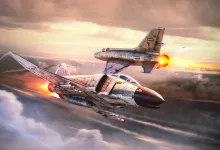 Two fighter jets fly through clouds with their afterburners glowing.