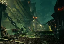 An industrial passage with hanging chains, corroded surfaces, and orange lights in Warhammer 40,000: Darktide.