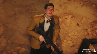 Bond wears a gold blazer and holds a rifle in a rocky setting in 007 First Light.