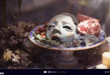 A pale mask, pomegranate, and other offerings arranged on a decorated altar with candles in ARC Raiders.