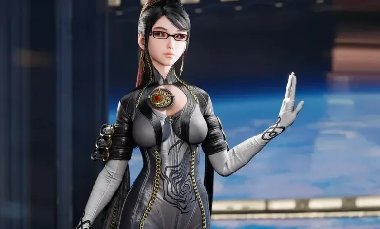 Bayonetta wears glasses and a black-and-silver outfit, raising one hand against a blue background.