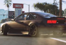A dark coupe turns across a city street in BeamNG.drive, kicking up dust behind it.