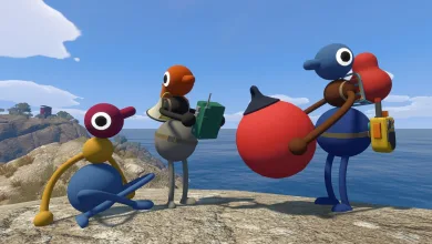 Four colorful Big Walk characters stand and sit on a rocky coastal overlook beside the sea.