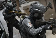 Two armored operators with rifles in a Call of Duty: Modern Warfare 4 multiplayer scene.