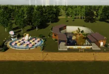 A teacup ride and animal habitat sit beside a path in a tree-filled Cities: Skylines II park.