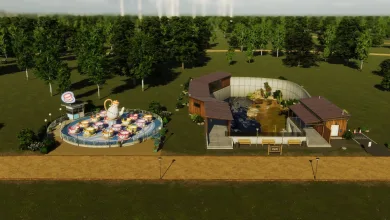A teacup ride and animal habitat sit beside a path in a tree-filled Cities: Skylines II park.