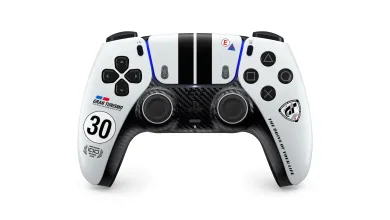 White DualSense controller with black racing stripes, a carbon-fiber-style center panel and Gran Turismo 30th-anniversary graphics.