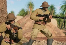A standing soldier holds a machine gun while another crouches nearby in a desert scene from Enlisted.