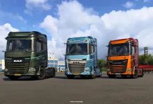Green Emerald, blue Sapphire, and orange anniversary DAF XG+ trucks lined up in a lot.