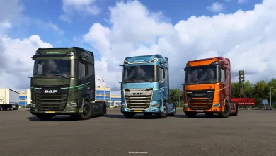 Green Emerald, blue Sapphire, and orange anniversary DAF XG+ trucks lined up in a lot.