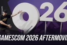 A man gestures toward an oversized 2026 display at Gamescom.