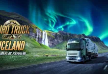 A truck drives along an Icelandic road past a waterfall beneath the northern lights.