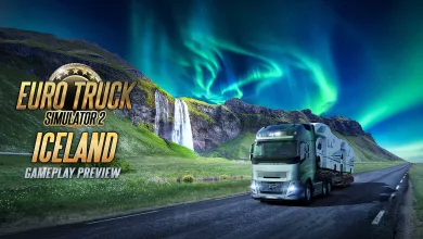 A truck drives along an Icelandic road past a waterfall beneath the northern lights.