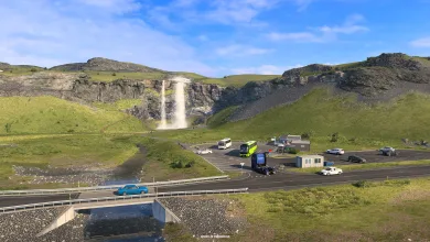 An in-game view of a waterfall, roadside parking area and vehicles in Iceland.