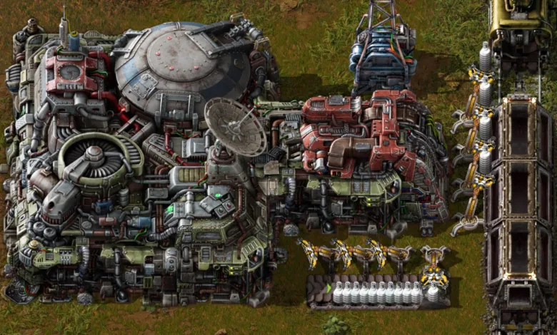 A dense Factorio factory with industrial machinery, production equipment, and robotic arms.
