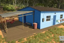 A blue farmhouse with a covered porch stands among the greenery in Farming Simulator 25.