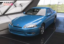 A blue 1997 Toyota Soarer displayed inside a bright showroom in Forza Horizon 5.