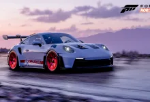 A white Porsche 911 GT3 RS with red wheels driving through a snowy landscape in Forza Horizon 5.