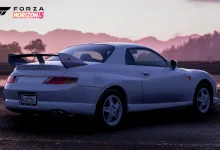 Rear three-quarter view of a light-colored Mitsubishi FTO with a prominent rear wing in Forza Horizon 5.