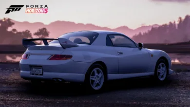 Rear three-quarter view of a light-colored Mitsubishi FTO with a prominent rear wing in Forza Horizon 5.