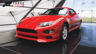 A red Mitsubishi FTO displayed in a Forza Horizon 5 showroom.