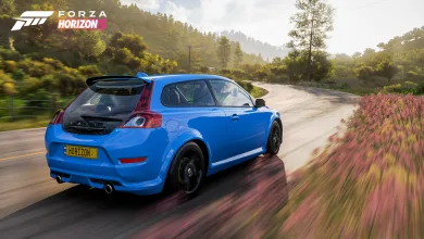Rear view of a blue Volvo C30 Polestar driving along a countryside road in Forza Horizon 5