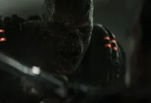 A snarling armored creature looms in the darkness in Gears of War: E-Day.