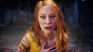 Close-up of red-haired Faye wearing yellow in a shadowy game environment.