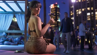 A woman in a patterned skirt holds a cocktail at a nighttime gathering, with a city skyline behind her.