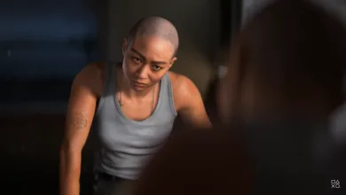 A bald character in a gray tank top leans forward in a dimly lit scene from Intergalactic: The Heretic Prophet.