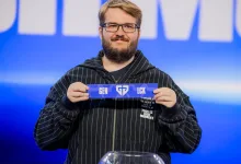 A representative holds a team card at the League of Legends Worlds 2026 draw.