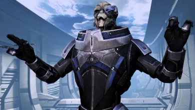Garrus stands with both hands raised in a bright futuristic interior.