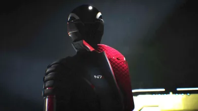 A helmeted figure in black armor with a red shoulder panel and an N7 insignia.