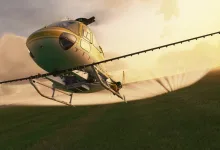 An Airbus H125 helicopter flying over fields at sunset in Microsoft Flight Simulator (2020).