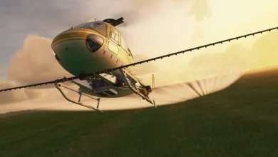 An Airbus H125 helicopter flying over fields at sunset in Microsoft Flight Simulator (2020).