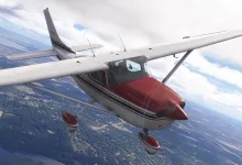 A white Carenado CT206 with a red nose and wheel fairings flies above a forested landscape.