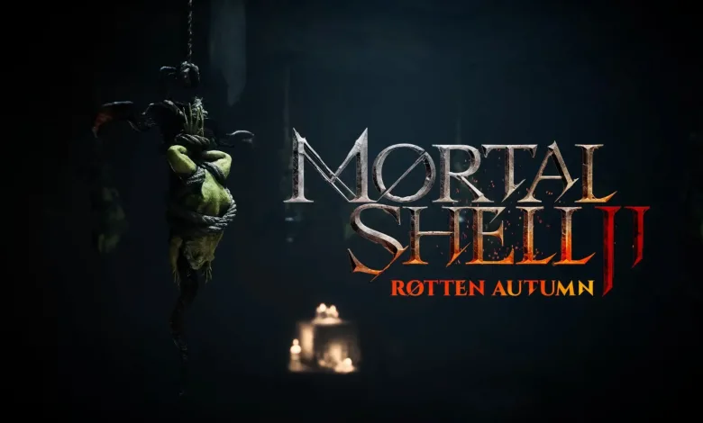 A bound, green-skinned figure hangs in a dark candlelit scene beside the Mortal Shell II: Rotten Autumn title logo.