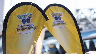 Yellow Pokémon GO Community Ambassador Program flags at an outdoor event.