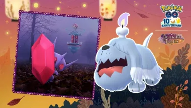 Greavard stands in the foreground of a Halloween-themed Pokémon GO scene, with Sableye shown in an inset.