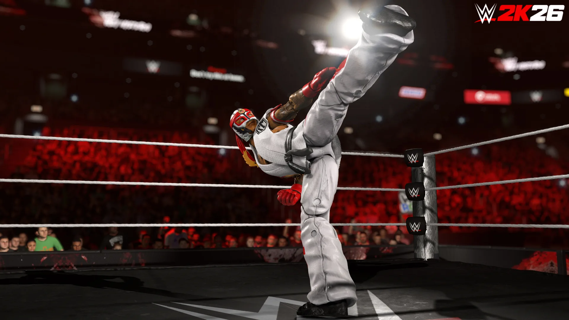 Rey Mysterio in a white Ryu-inspired gi delivering a high kick in the ring