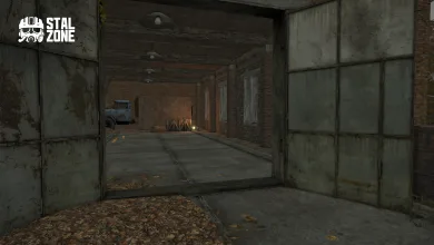 An abandoned garage interior seen through open metal doors, with a truck and crates inside.