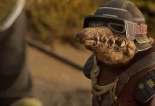 A close-up of a tusked alien racer wearing dark flight goggles and brown racing gear in Star Wars: Galactic Racer.