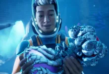 A diver in a Subnautica 2 suit holds a pale alien creature underwater.