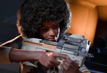 A COMETA-marked contestant holds a futuristic weapon in THE FINALS.