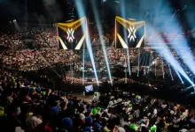 A packed esports arena with VALORANT Champions banners above the stage.