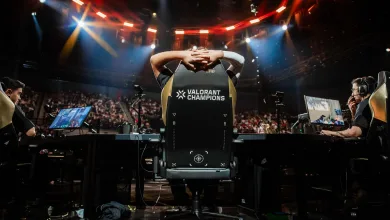 VALORANT Champions player seated at a gaming station onstage beneath arena lights