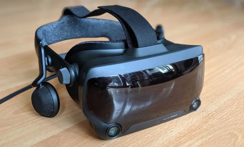 A Valve Index VR headset with its head strap, side speaker, and front sensors resting on a wooden table.