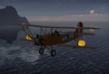 A biplane with bat and pumpkin decorations flies over the sea at dusk.