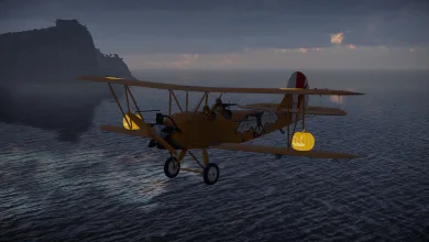 A biplane with bat and pumpkin decorations flies over the sea at dusk.